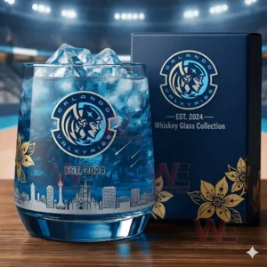 A blue Orlando Valkyries themed whiskey glass with ice sits beside a matching logo box on a wooden table!