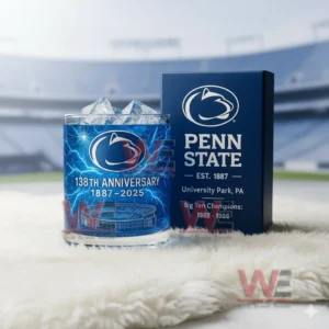 Penn State Nittany Lions 138th Anniversary 1887-2025 Whiskey Glass 5 A Penn State anniversary glass and box set shown on a white surface with blurred stadium seats behind them!