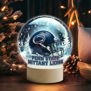 A snow globe with a dark blue team helmet is displayed near pine branches and warm festive lighting!
