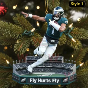 Christmas tree ornament featuring a Philadelphia Eagles player in a green number one jersey posed in motion above a stadium base with text reading Fly Hurts Fly.