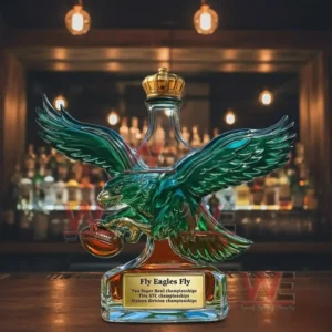 Philadelphia Eagles Wing 2-Time Super Bowl Champions Whiskey Bottle 5 Eagle wing glass bottle with crown top showcased on a bar surface with warm lighting!