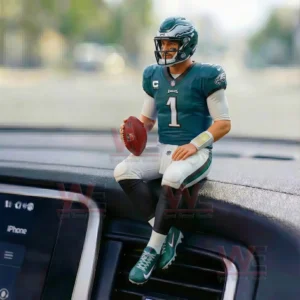 Philadelphia Eagles quarterback figurine sitting on a car dashboard holding a football in a realistic pose!
