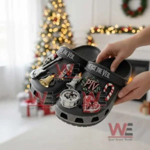 Pierce the Veil Christmas Crocs Crocband Clogs with Charms 4 Hands holding decorated clogs with themed charms in a festive room with a Christmas tree behind!