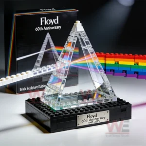 Clear prism brick sculpture on a black base showing rainbow light details as a collectible display piece!