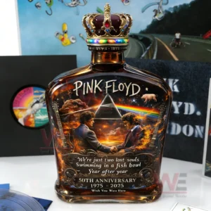 Whiskey bottle with Pink Floyd inspired artwork prism rainbow handshake figures and rich amber glass displayed on a music themed background!