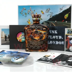 Decorative whiskey bottle with Pink Floyd inspired imagery placed in front of vinyl records and album covers!