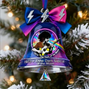 Music inspired christmas bell with guitarist artwork and bright colors hanging on a decorated tree!