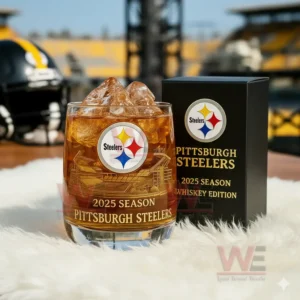 Pittsburgh Steelers 2025 Season Whiskey Glass 4 Steelers themed whiskey glass with ice and branded box displayed on a soft surface in a stadium backdrop!