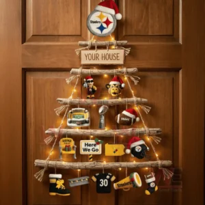 A rustic wooden wall tree on a wooden door decorated with pittsburgh steelers themed ornaments and warm holiday lights!