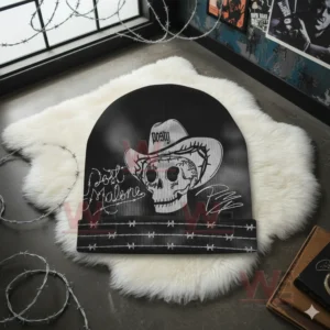 Black Post Malone beanie with skull cowboy graphic and barbed wire design on white rug.
