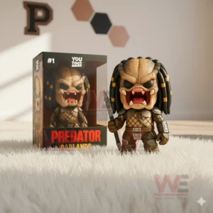 Predator Badlands figure with spear beside its box on a rug in a sporty room.