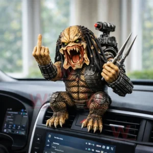Predator style creature figure displayed on a car dashboard with claws weapons and an intense roaring expression!