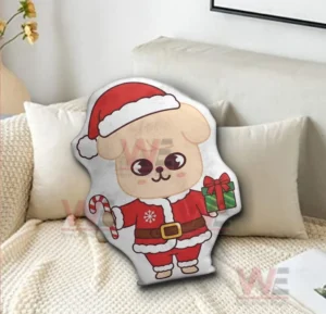 Puppy santa pillow sitting on a sofa with a festive and cozy atmosphere!