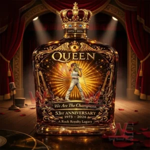 Ornate Queen anniversary whiskey bottle with crown cap shown on a stage with red curtains spotlights and a label featuring a singer with golden rays and 53rd anniversary 1973 2026 text.