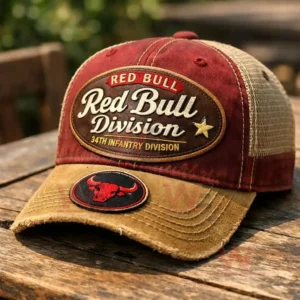 Red and tan distressed trucker cap with an embroidered Red Bull Division 34th Infantry Division patch a bull logo badge on the brim and beige mesh back.