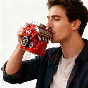 A man drinking coffee from a red engine inspired mug while standing against a light background!