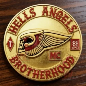 A gold coin with a central winged skull design and surrounding text referencing a motorcycle club theme!