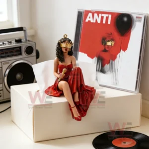 Red gown singer figurine sitting on a tissue box next to an Anti album case with a boombox and vinyl record nearby!