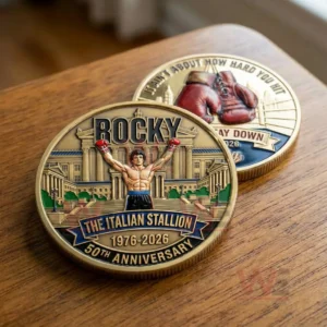 Golden Rocky anniversary coin with a victorious boxer pose and grand building background!