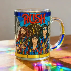 A transparent stained style mug with colorful band artwork displayed on a wooden table with reflections of light around it!