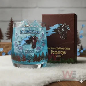 A blue Pomeroys glass with ice shown on a soft white surface with floral and tree decorations around it!