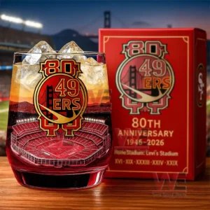 Whiskey glass with ice and football stadium artwork displayed beside a red anniversary box on a table!