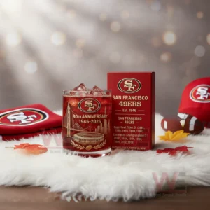 San Francisco 49ers 80th Anniversary 1946-2026 Whiskey Glass 5 A San Francisco Forty Niners themed anniversary glass and box displayed with surrounding team accessories and soft lighting!