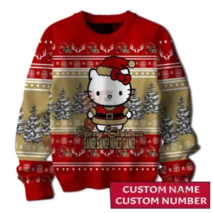 Front close up view of a red and gold holiday sweater displaying a cute festive character centered among snowy trees and decorative team motifs!