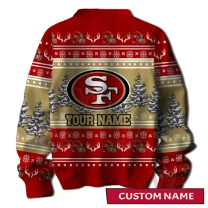 Back view of a red and gold holiday sweater with a large team logo placed over snowy trees and repeating themed decorations!