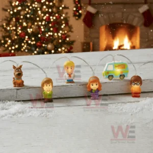 Scooby doo themed string lights displayed on a snowy wooden surface with character figures and glowing decorations in a holiday room!