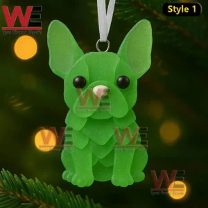 Green sea glass french bulldog ornament hanging on a christmas tree with soft glowing lights!