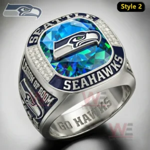 Seattle Seahawks ring with square blue green gemstone top hawk logo clear stone border and Seahawks lettering with legion of boom side text and go hawks engraving.