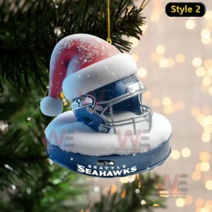 Ornament of a Seahawks helmet wearing a Santa hat on a snowy blue base!
