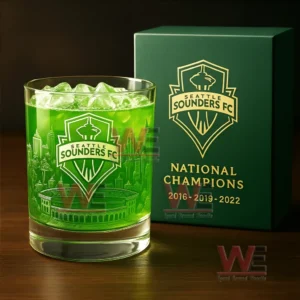 Green Seattle Sounders FC whiskey glass with ice next to a branded gift box on a wooden surface!