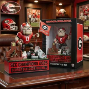 Georgia Bulldogs collectible bulldog figure holding a flag and football standing on a defeated elephant mascot on an SEC Champions two thousand twenty five base with the retail box beside it.