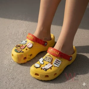 Seinfeld Crocs Crocband Clogs With Charms 5 Feet wearing yellow clogs adorned with multiple comedy themed charms displayed clearly in natural light!