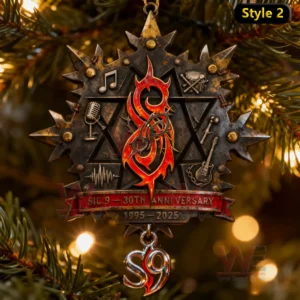A musical themed metal ornament with engraved symbols arranged around a bright central emblem displayed among tree branches!