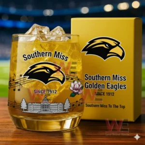 Southern Miss Golden Eagles whiskey glass with ice and golden drink shown next to a branded box in a lively arena setting!