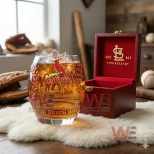 A St Louis Cardinals themed anniversary glass positioned beside an open wooden box on a soft surface!
