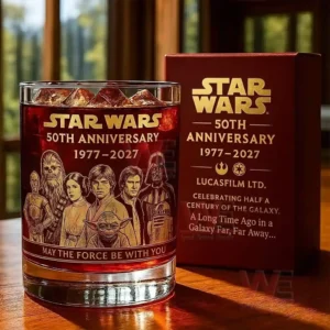 Anniversary themed whiskey glass with character artwork displayed beside a red gift box!
