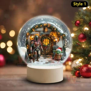 Star Wars Christmas Snowball Decoration Led Light 5 A snow globe showing an armored figure and a small green child before a warmly lit holiday decorated house in a snowy landscape!