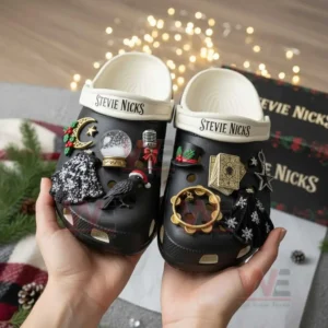 Decorated black clogs with symbolic charms inspired by music magic and winter aesthetics displayed close up in hands!