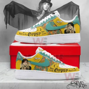 Custom yellow and teal Nike Air Force One sneakers with Stevie Nicks inspired portraits and gypsy themed text displayed on a red shoebox with a grayscale portrait backdrop