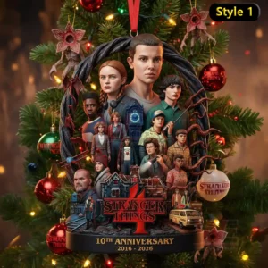 Stranger Things 10th Anniversary 2016-2026 Ornament 5 The image displays a Stranger Things themed ornament showing the main cast placed inside a circular dark frame with holiday decorations.