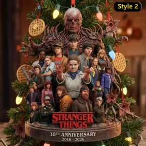 Stranger Things 10th Anniversary 2016-2026 Ornament 6 The image displays a Stranger Things ornament showing major characters and a creature posed before a decorated Christmas tree in a snowy setting.