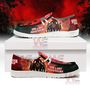 Stranger Things 5 One Last Adventure Hey Dude Shoes 7 Side view of Stranger Things shoes with character group art and a fiery themed design!