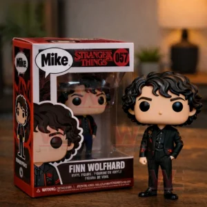 Boxed vinyl style figure labeled Mike from Stranger Things shown beside the matching curly haired figure on a wooden table!