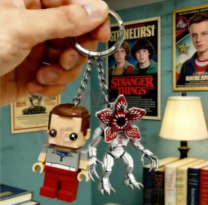 Keychain figures inspired by Stranger Things with one human character and one monster character hanging from a metal ring!