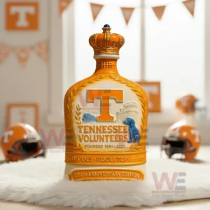 Tennessee Volunteers 134th Anniversary 1891-2025 Whiskey Bottle 5 Orange Tennessee Volunteers bottle with crown top placed on a white rug surrounded by football helmets and orange decor!