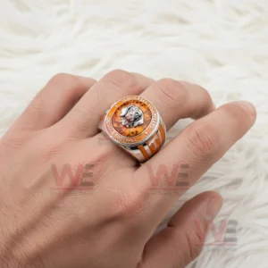 Hand wearing Tennessee Volunteers ring with orange gemstone face and dog mascot emblem.